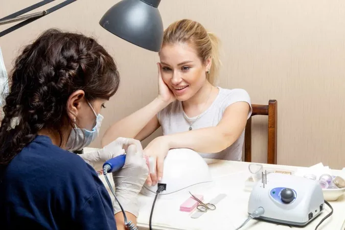 Front View Young Female Getting Her Nails Fixed By Manicurist Inside Room Beauty Manicure Nails Hand Self Care X - Certified Medical Nail Technician study guide