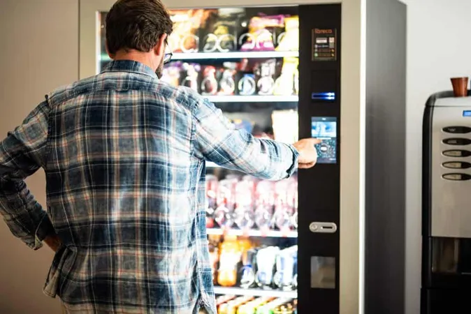 Rear View Man Using Vending Machine X - National Automatic Merchandising Association Certification study guide
