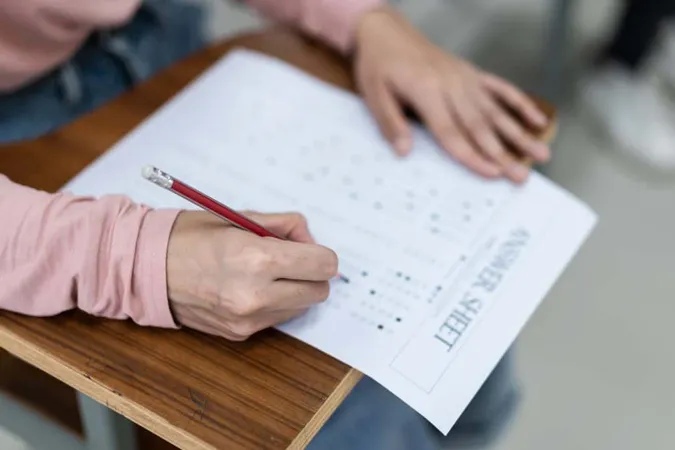 Close Up Young Female University Students Concentrate Doing Examination Classroom Girl Student Writes Answer Examinations Answer Sheet Classroom 1 X - Nebraska Student-Centered Assessment System study guide
