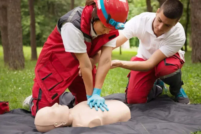 Healthcare Workers Practicing Cpr Dummy Park X - Occupational First Aid Certification study guide