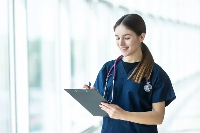 Smiling Young Female Doctor Holding Clipboard Hospital - Registered Health Specialist Certification study guide