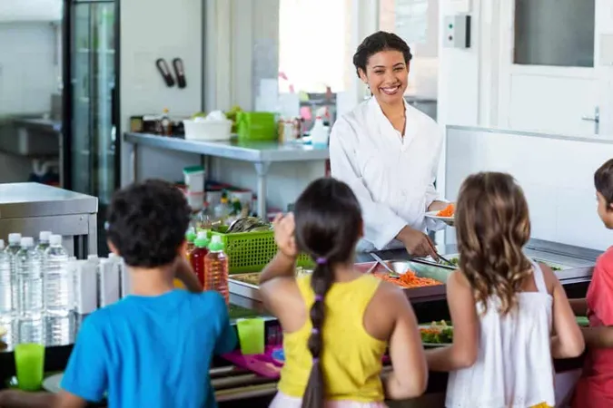 Woman Serving Food Schoolchildren X - School Nutrition Association Certification study guide