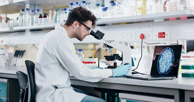 Medical Research Man With Microscope Science Check Experiment Cancer Treatment Person Scientist Employee With Lab Equipment Laptop Cure Development With Particles Biotech X - Specialist in Microbiology study guide