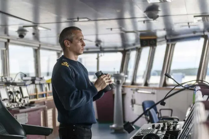 Deck Officer With Binoculars Nav - Standards Certification and Watchkeeping for Seafarers study guide