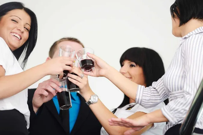 Business Group Celebrating Victory Holding Glasses With Drink X - Wine &amp; Spirit Education Trust Certification study guide