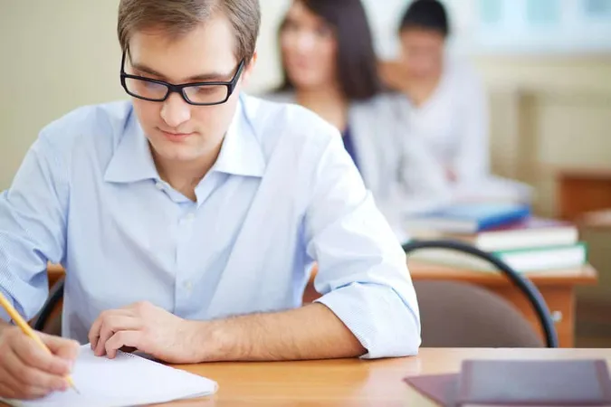Student With Glasses Writing 1 - WorkKeys study guide