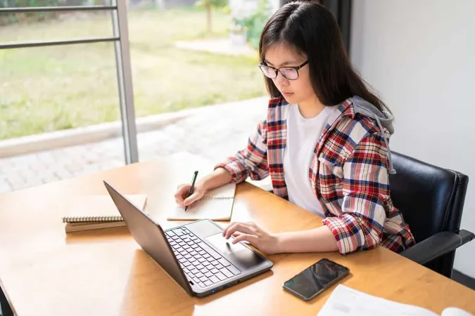 Young Female Student Working Stu - WorkKeys study guide
